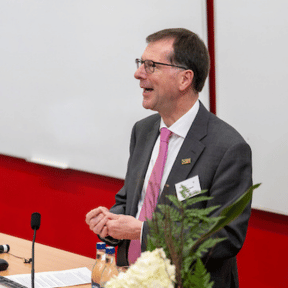 President of university speaking to guests 