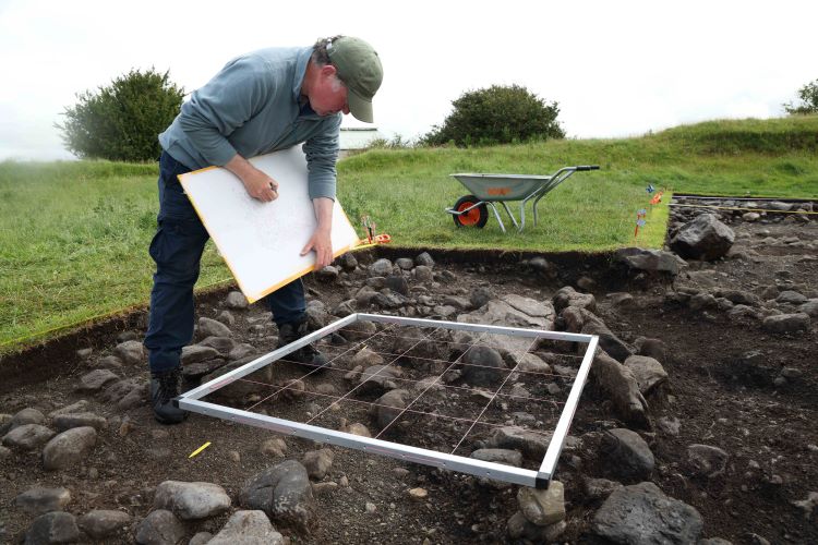 Dr Noel McCarthy drawing an archaeological feature at Rathgurreen ringfort excavations, 2025