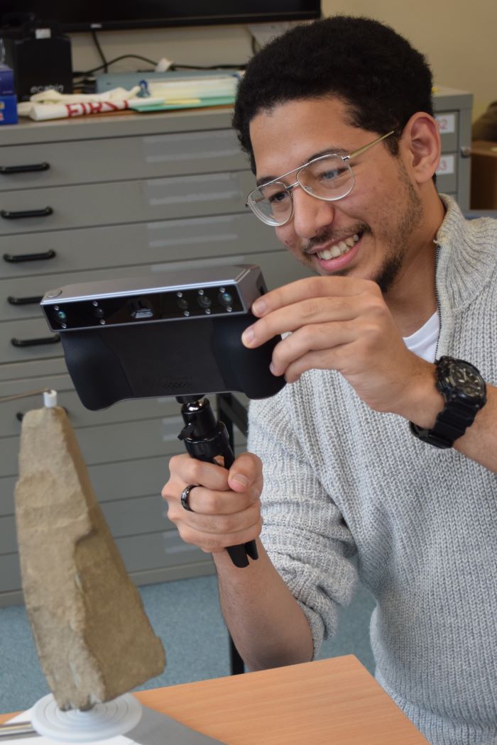 Yousef Konswah scanning an ogham inscription in the Archaeology department