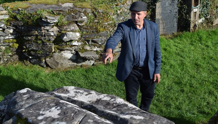 Professor Benbouzid pointing to rock art on the Boheh Stone, Co. Mayo.