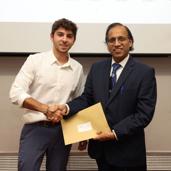 Male student receiving her award from academic
