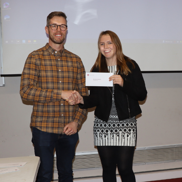 female student receiving her award from academic