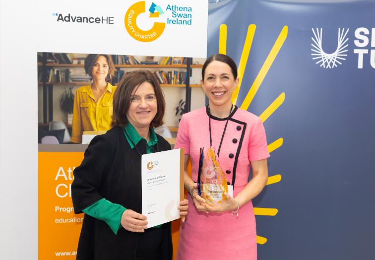 Anne and Ciara holding the award certificate and award trophy
