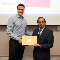 Male student receiving her award from academic