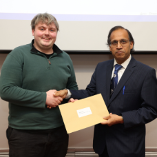 Male student receiving her award from academic