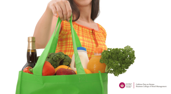 lady carrying shopping bag with groceries