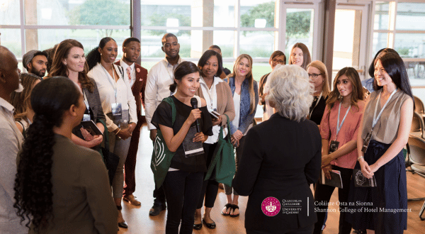 group of men and women from all nationalities around a circle chatting
