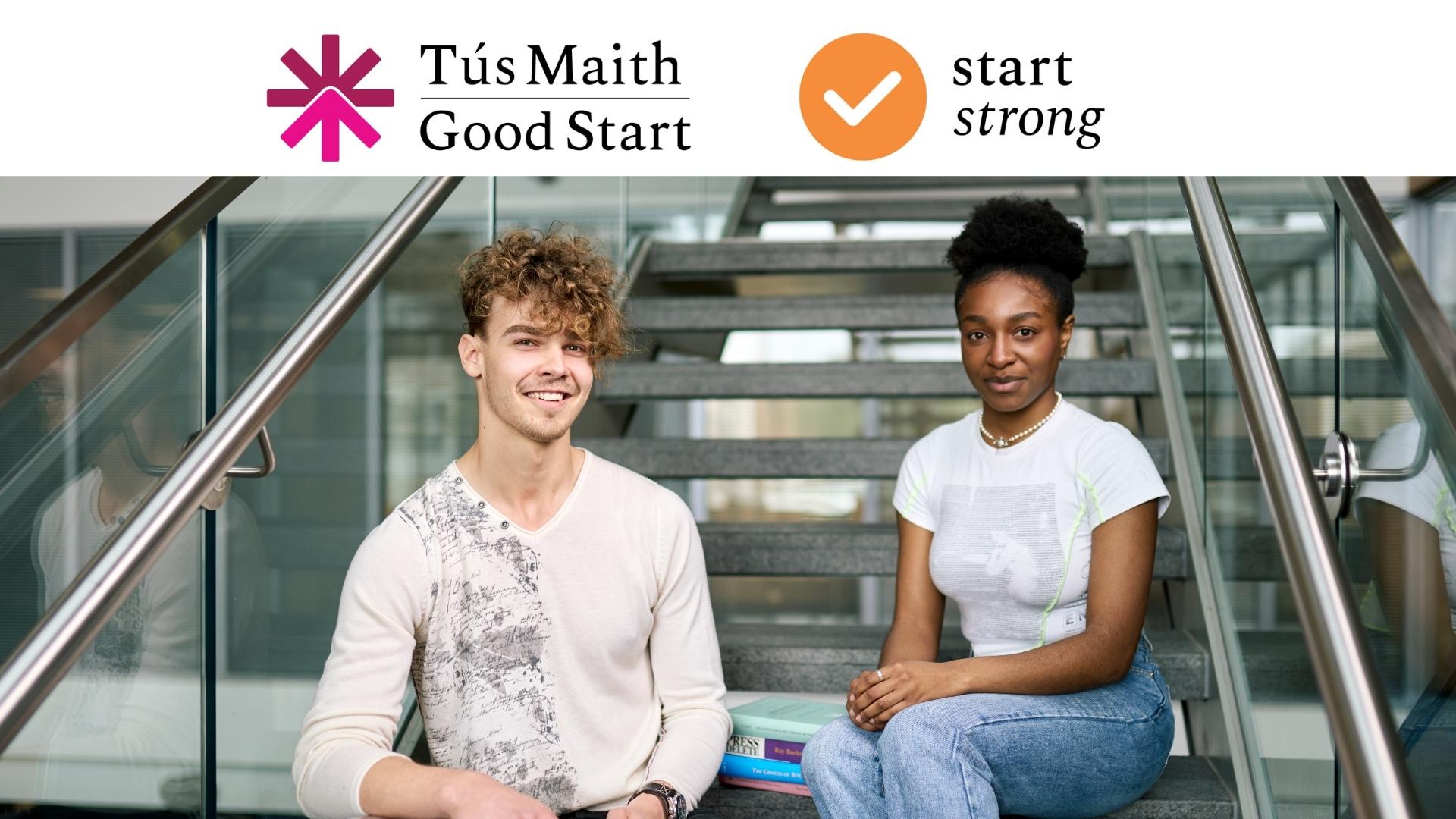 Two students sitting on the main stairs inside the Hardiman Library Foyer