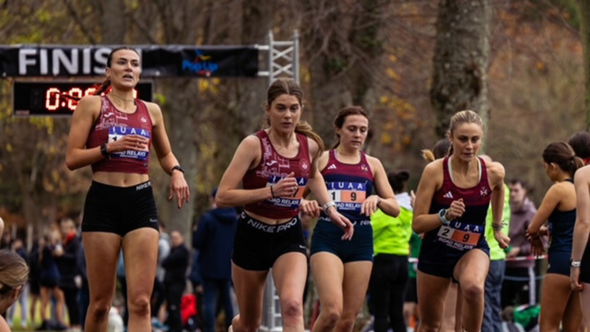 photo of three female students running in a race