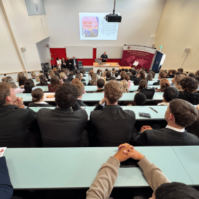 photo of all guests and students smiling in the auditorium 